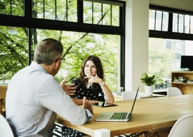 Coworkers having discussion at table