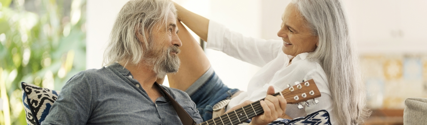 Mature Couple Playing Music on Couch