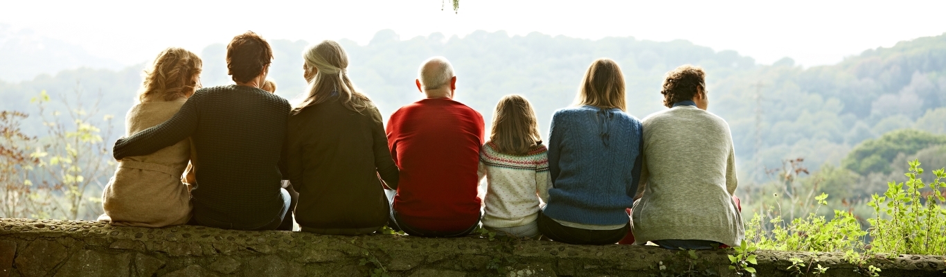 Multiple Generations of Family Sitting on Retaining Wall