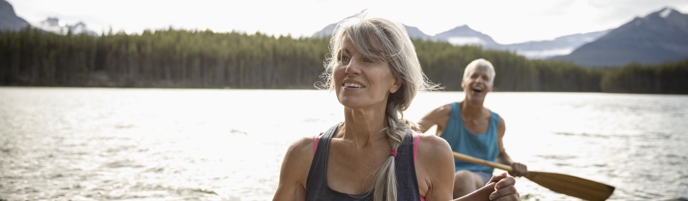 Mature Couple Canoeing on Lake