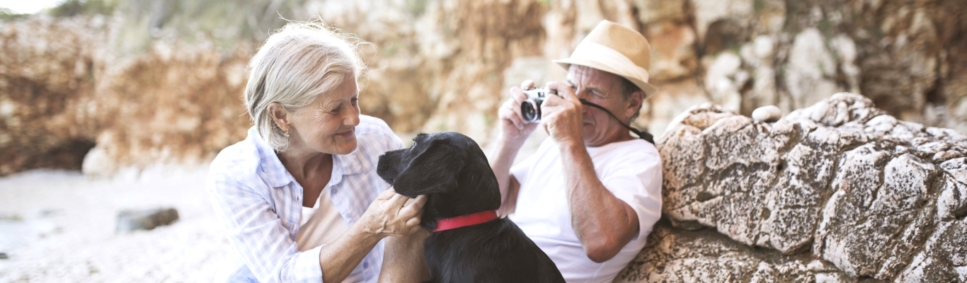 Senior Couple with Black Dog on Beach