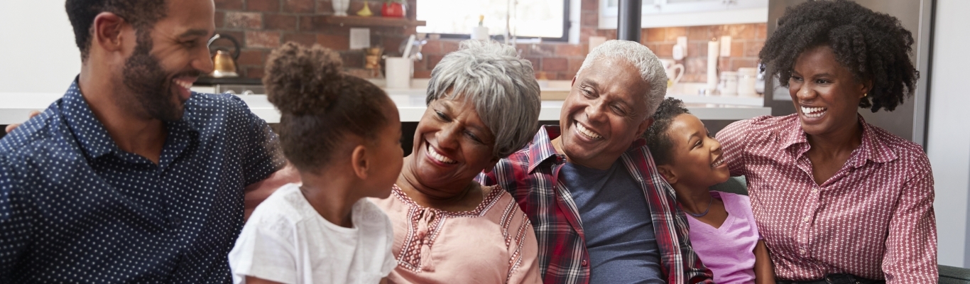 Multi-Generational Family Smiling and Laughing on Couch