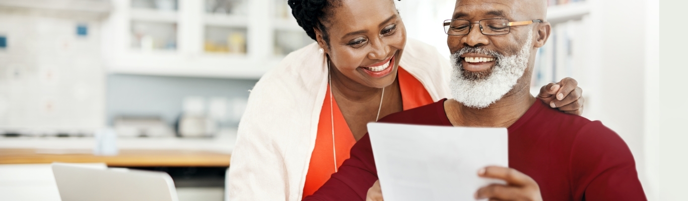 Couple looking at papers at kitchen table