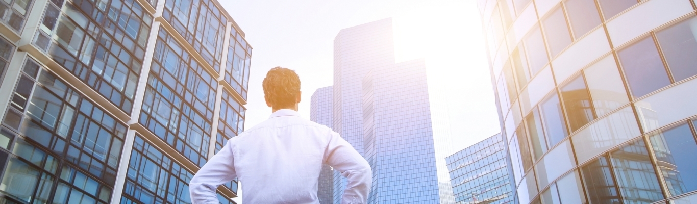 Business Man Looking Up at Buildings