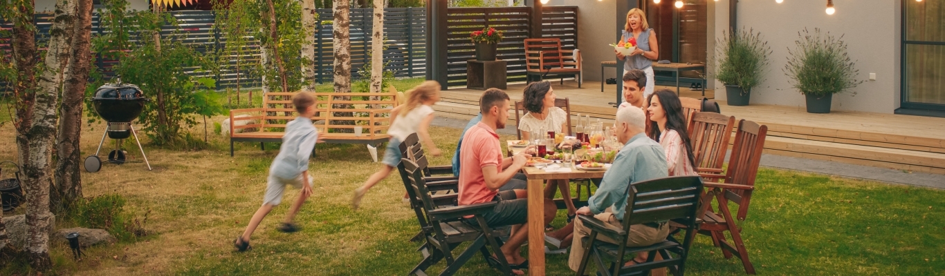 Family gathering outside for meal
