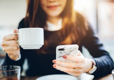 Woman with Coffee Mug and Phone